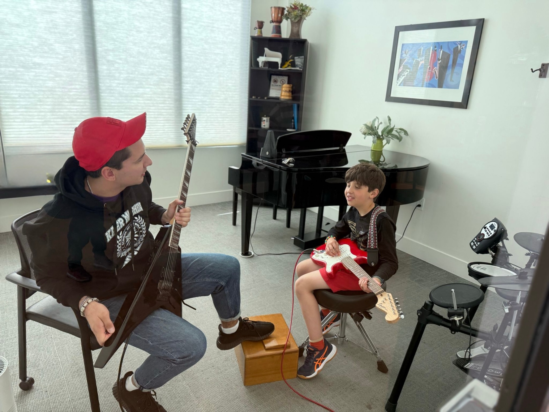 Private guitar lesson with an instructor and a young student at Opus11